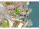 Aerial view of a charming waterfront home with a private dock, surrounded by lush greenery and tranquil lake waters at 7591 Inkbush Dr, Nineveh, IN 46164