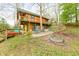 Spacious backyard with fire pit and tiered landscaping, perfect for outdoor entertaining at 7591 Inkbush Dr, Nineveh, IN 46164