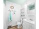 Classic white bathroom features beadboard paneling and nautical-themed decorations at 7591 Inkbush Dr, Nineveh, IN 46164