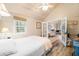Cozy bedroom featuring wood floors, natural light, and a comfortable bed with access to another living space at 7591 Inkbush Dr, Nineveh, IN 46164