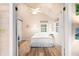 Bright bedroom with light walls, wood floors and white bedding create a serene and airy space at 7591 Inkbush Dr, Nineveh, IN 46164