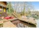 Multi-level dock with access to the lake and stairs leading to the log cabin, blending outdoor living with lake activities at 7591 Inkbush Dr, Nineveh, IN 46164