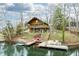 Charming lake house with a wooden exterior, large deck, and private dock for serene waterfront living at 7591 Inkbush Dr, Nineveh, IN 46164