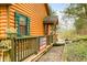 Charming log cabin features a cozy porch with wood railings and colorful accents at 7591 Inkbush Dr, Nineveh, IN 46164