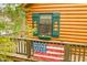 Charming log cabin detail with American flag and window box at 7591 Inkbush Dr, Nineveh, IN 46164