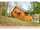 Charming log cabin home with a welcoming porch, nestled among the trees and greenery at 7591 Inkbush Dr, Nineveh, IN 46164