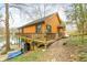 Lake-view cabin showcasing a wooden deck and a covered area underneath the home at 7591 Inkbush Dr, Nineveh, IN 46164