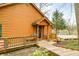 Log cabin exterior featuring a cozy porch with lake view, accessible by wooden stairs at 7591 Inkbush Dr, Nineveh, IN 46164
