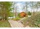 Log cabin home with a wooden walkway and staircase leading up to the entrance by the lake at 7591 Inkbush Dr, Nineveh, IN 46164