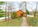 Beautiful cabin home nestled amongst the trees with a path leading to the tranquil lake at 7591 Inkbush Dr, Nineveh, IN 46164