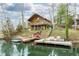 Lakefront cabin with multiple docks and decks, showcasing the tranquil waterfront setting at 7591 Inkbush Dr, Nineveh, IN 46164