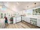 Bright, airy kitchen with a vintage stove, white cabinets, and wood floors at 7591 Inkbush Dr, Nineveh, IN 46164