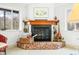 Cozy fireplace featuring a brick surround and a rustic wood mantle at 7591 Inkbush Dr, Nineveh, IN 46164