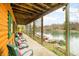 Charming porch with comfortable seating overlooking the lake and dock area, blending nature with outdoor living at 7591 Inkbush Dr, Nineveh, IN 46164