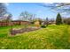 Spacious backyard featuring grass and mature trees and wooden fence at 7714 Kenneth Ct, Brownsburg, IN 46112