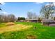 Expansive backyard with grass, mature trees, and a glimpse of the home's exterior at 7714 Kenneth Ct, Brownsburg, IN 46112