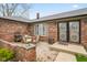 Cozy brick patio featuring an outdoor table setting and mature landscaping at 7714 Kenneth Ct, Brownsburg, IN 46112