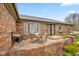 Outdoor brick patio seating area with a table set on a paved surface at 7714 Kenneth Ct, Brownsburg, IN 46112