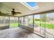 Inviting sunroom with large windows, ceiling fan, tile flooring, and access to a backyard at 7714 Kenneth Ct, Brownsburg, IN 46112