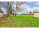 Wide backyard with mature trees and a well-maintained lawn, offering ample space for outdoor activities at 7764 S State Road 109, Markleville, IN 46056