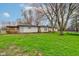 Lush backyard featuring a covered patio, spacious lawn, and easy access to the detached garage at 7764 S State Road 109, Markleville, IN 46056