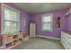 Bright bedroom features lilac walls, carpeted floor, and bright natural light at 7764 S State Road 109, Markleville, IN 46056