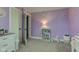 Lilac bedroom features a grey carpet, bright lighting, and whimsical decor at 7764 S State Road 109, Markleville, IN 46056