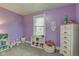Bright bedroom featuring lilac walls, grey carpet, and lots of storage at 7764 S State Road 109, Markleville, IN 46056