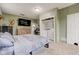 Comfortable bedroom featuring closet laundry, natural light, neutral tones, and mounted television at 7764 S State Road 109, Markleville, IN 46056
