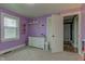 Bedroom featuring lilac walls, grey carpet and natural light at 7764 S State Road 109, Markleville, IN 46056