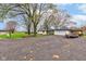 Residential home featuring a detached garage and a spacious, graveled driveway at 7764 S State Road 109, Markleville, IN 46056