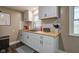 Updated kitchen offers modern finishes including white cabinets, wood countertop and mosaic backsplash at 7764 S State Road 109, Markleville, IN 46056
