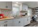 Bright kitchen with sleek white cabinets, butcher block counters, and modern mosaic backsplash at 7764 S State Road 109, Markleville, IN 46056