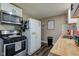 Clean kitchen features stainless appliances, modern cabinets and countertops with lots of storage at 7764 S State Road 109, Markleville, IN 46056