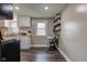 Kitchen showcasing white cabinets, butcher block countertops, and floating shelves for pantry storage at 7764 S State Road 109, Markleville, IN 46056