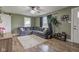 Spacious living room featuring a sectional sofa, and plank flooring at 7764 S State Road 109, Markleville, IN 46056