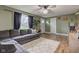 Inviting living room featuring a plush sectional sofa, wood-look floors and a ceiling fan at 7764 S State Road 109, Markleville, IN 46056