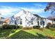 Back exterior of the house features a well-maintained lawn, and mature landscaping at 8040 Lynch Ln, Indianapolis, IN 46250