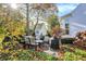 Cozy backyard with a patio set, grill, and lush foliage, creating a relaxing outdoor space at 8040 Lynch Ln, Indianapolis, IN 46250