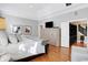 Spacious bedroom with hardwood floors, large dresser, and adjacent walk-in closet at 8040 Lynch Ln, Indianapolis, IN 46250