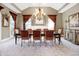 Elegant dining room with coffered ceiling, featuring a large dining table and ornate chandelier at 8040 Lynch Ln, Indianapolis, IN 46250