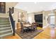 Bright dining area with hardwood floors, adjacent to the staircase, and complemented by black cabinetry at 8040 Lynch Ln, Indianapolis, IN 46250