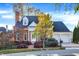 Charming brick home with dormers, two-car garage, and colorful landscaping at 8040 Lynch Ln, Indianapolis, IN 46250