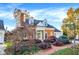 Well-maintained brick home featuring mature trees and manicured garden beds at 8040 Lynch Ln, Indianapolis, IN 46250
