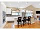 Open-concept kitchen featuring white cabinets, an island, and stainless steel appliances at 8040 Lynch Ln, Indianapolis, IN 46250
