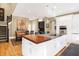 Spacious kitchen island with a wood countertop and white cabinets, offering ample seating at 8040 Lynch Ln, Indianapolis, IN 46250