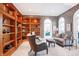 Inviting living room with custom built-in bookshelves and patterned wall coverings, creating a cozy atmosphere at 8040 Lynch Ln, Indianapolis, IN 46250