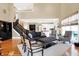 Expansive living room blending style and comfort, adjacent to a staircase and white kitchen at 8040 Lynch Ln, Indianapolis, IN 46250