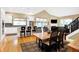 Open living space with kitchen island, a dining table, and stairs to the second level at 8040 Lynch Ln, Indianapolis, IN 46250