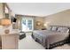 Spacious bedroom featuring a comfortable bed, dresser, and a bright window view at 8040 Lynch Ln, Indianapolis, IN 46250